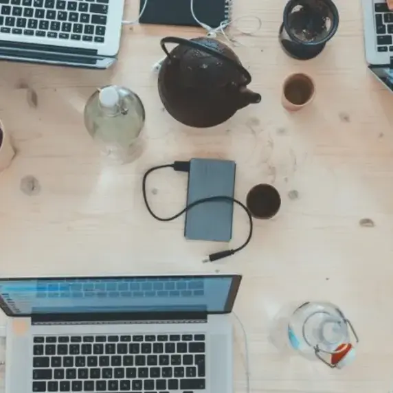 A bunch of laptops on a table from above