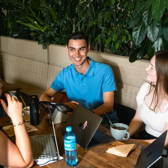Drie studenten aan een tafel