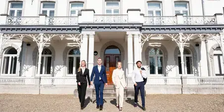 Hotel Management - 4 studenten voorkant gebouw